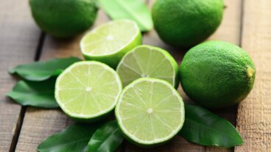 Fresh limes lie on a table