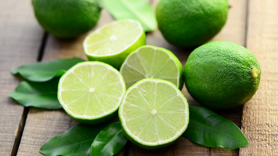 Fresh limes lie on a table